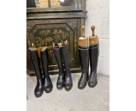 Pair of ladies black leather hunting boots with wooden trees, together with two other pairs