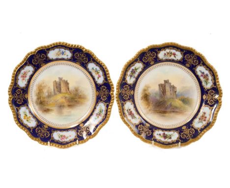 Two Royal Worcester scalloped plates, painted by Stinton with scenes of Invergarry Castle, the border with floral panels on a
