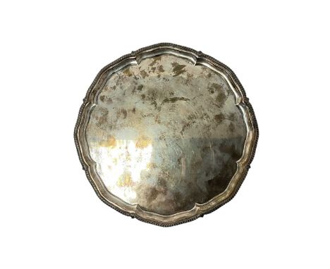 Early 20th century silver salver of octagonal form, with narrow gadrooned border, on four scroll feet (Sheffield 1921) George