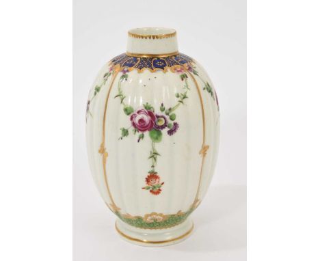 A Worcester tea caddy, circa 1780, of fluted form, polychrome painted with floral swags in gilt panels, with a blue and gilt 