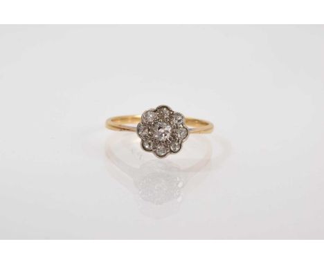 Antique diamond daisy cluster ring with nine old cut diamonds in platinum setting on 18ct gold shank, ring size K.Good condit