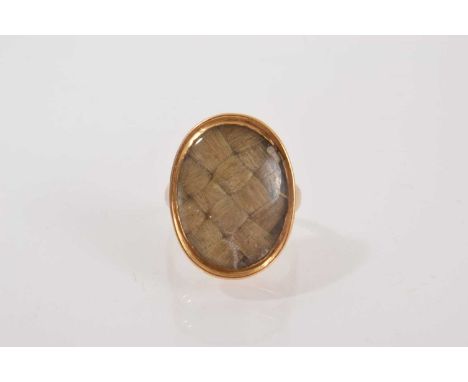 George III mourning ring with an oval bezel containing a panel of plaited hair in gold setting, ring size approximately G.
