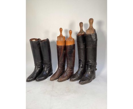 Three pairs of vintage black leather hunting boots including Maxwell, one pair with wooden Tom Hill trees