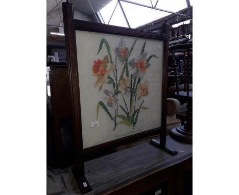 An embroidered firescreen in oak frame 
