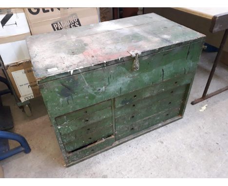 A large wooden tool chest with drawers and tools 