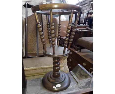 A revolving jardiniere holder with bobbin turnings 