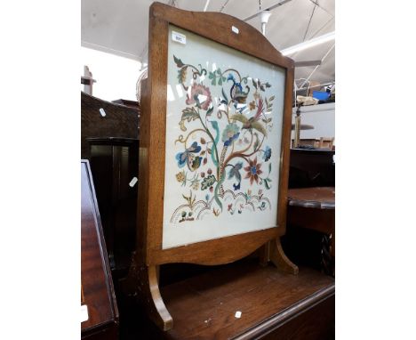 An embroidered firescreen/table 