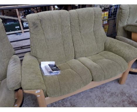 An Ekornes Stressless reclining two seater settee in light green cloth upholstery 