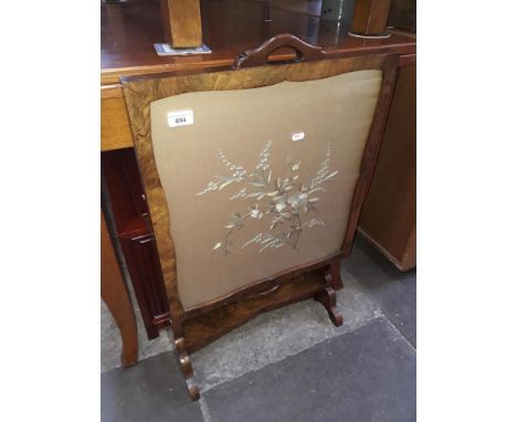 An embroidered firescreen/table 