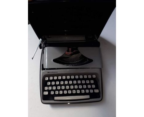 A Remington Envoy portable typewriter in hard caseCondition: some keys slightly sticky, otherwise appears ok, no signs of any