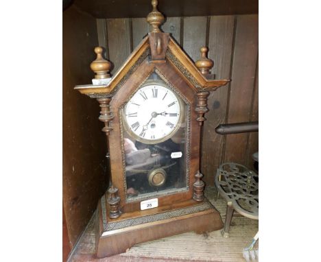 A wooden cased mantle clock with pendulum and key 