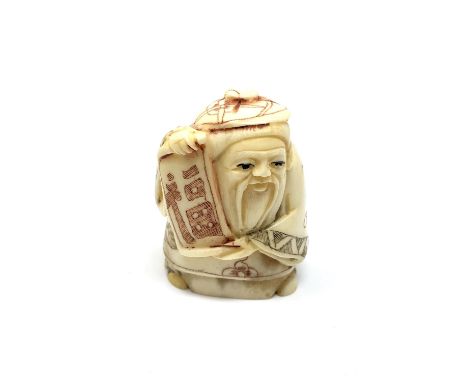 A carved Chinese bone netsuke - Village elder with scroll