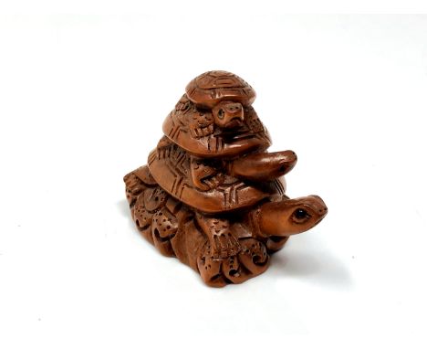 A carved Chinese hardwood netsuke - Turtle family 