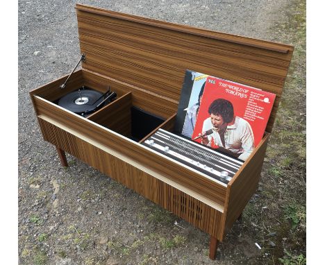 A 1960's record player / radio cabinet, circa 1965. CONDITION REPORT: Tested in working order.