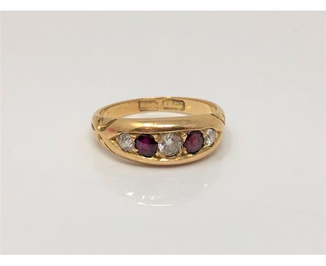 An antique 18ct gold ruby and diamond ring, size M CONDITION REPORT: 4.5g The central diamond approximately 3 mm in diameter.