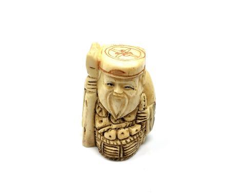A carved Chinese bone netsuke - Gentleman holding a staff with basket 