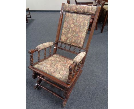 A stained beech rocking chair in tapestry upholstery 
