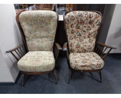A pair of Ercol stained elm spindle back high back armchairs 