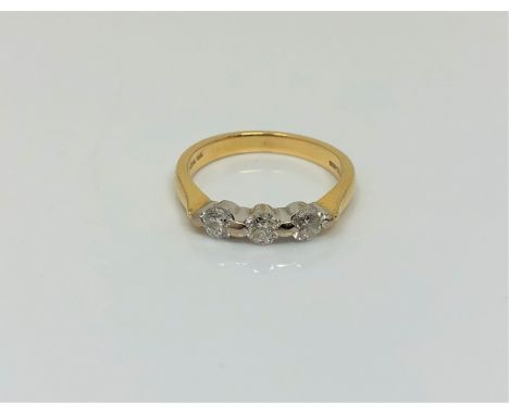 An 18ct gold three stone diamond ring, size K1/2 CONDITION REPORT: 3.3g