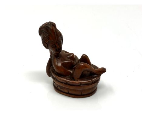 A carved Chinese hardwood erotic netsuke - nude bathing