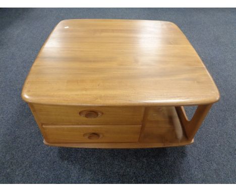 An Ercol elm Pandora's box coffee table on castors 