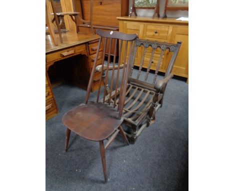 An Ercol carved back armchair (lacks cushion) together with a high back spindle dining chair (2) 