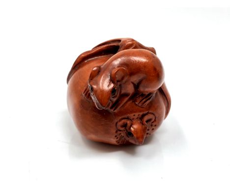A carved Chinese hardwood netsuke - Two rats on fruit