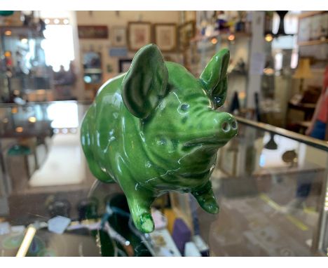 A rare Wemyss pottery green pig circa 1900. CONDITION REPORT: Area of re-touching to the pig's front-right hoof. The opposite