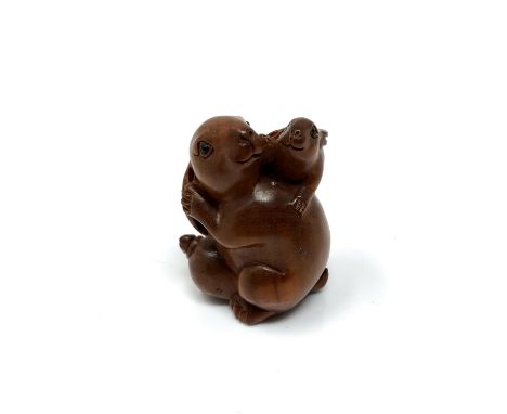 A carved Chinese hardwood netsuke - Rabbit family 