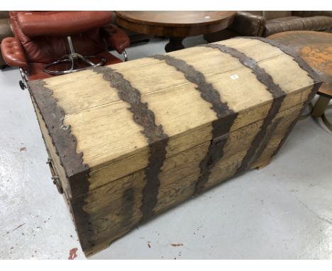 A nineteenth century oak and metal bound dome topped trunk 