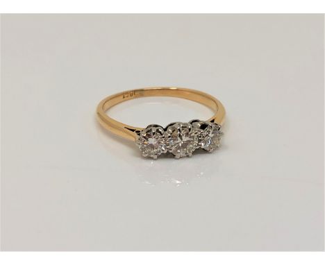 An 18ct gold three stone diamond ring, size M CONDITION REPORT: 2.4g