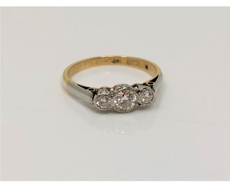 An 18ct gold three stone diamond ring, size M CONDITION REPORT: 2.5g