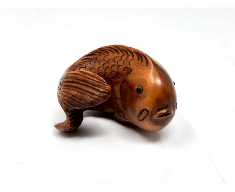 A carved Chinese hardwood netsuke - Carp