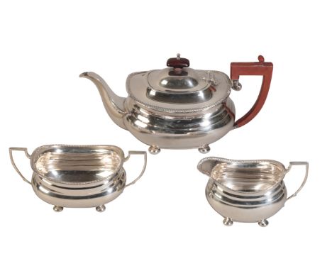 A GEORGE V SILVER TEA SETby D&J Welby, London 1936, with squat oval bodies on ball feet, comprising teapot, milk jug and suga