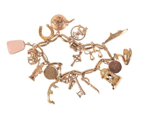 A VINTAGE CHARM BRACELETin 9ct gold, comprising a fancy link bracelet suspending sixteen charms, stamped 'S&P', full British 