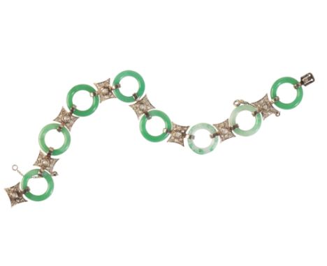A BELLE-EPOQUE JADEITE JADE AND DIAMOND BRACELETin platinum, comprising a series of jadeite jade rings, alternating with styl
