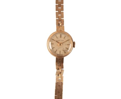 CERTINA: A LADY'S 9CT GOLD BRACELET WATCHwith manual wind movement, the silver dial with gold baton numerals and gold hands, 