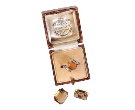 A CITRINE AND DIAMOND RINGin 14ct white gold, set with an oval cut citrine of c.2.32 carats held in a claw setting, flanked b