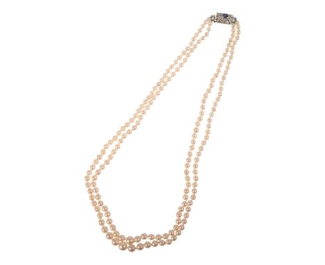 A VINTAGE SAPPHIRE AND DIAMOND TWO-ROW PEARL NECKLACE comprising two rows of graduating cultured pearls, measuring 3.2-7.1mm,