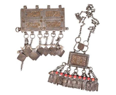AN OMANI HIRZ WHITE AND GILT METAL NECKLACEof rectangular geometric design with suspended coral beads and white metal tassels
