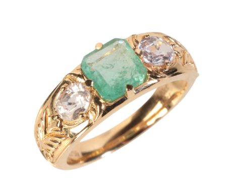 AN EMERALD AND SAPPHIRE THREE STONE RINGin 18ct gold, set with a step cut emerald of 1.20 carats, held in a claw setting, fla