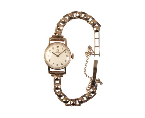 OMEGA: A LADY'S 9CT YELLOW GOLD WRISTWATCHwith a manual wind movement, the silvered dial with applied Arabic numerals and pai