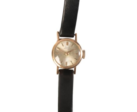 GIRARD PERREGAUX: A LADY'S GOLD WRISTWATCHwith manual wind movement, the silver dial with gold baton numerals and hands, no. 