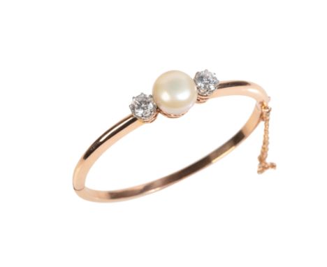 A PEARL AND CZ BANGLEin 9ct gold, set with a cultured pearl of 13.2mm, flanked by round cut cubic zirconias of 6.5mm diameter