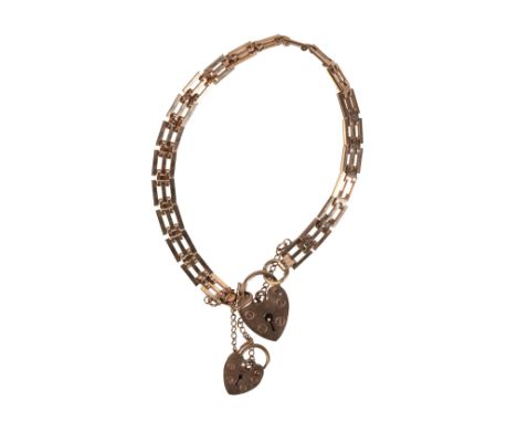 AN VINTAGE GATE LINK BRACELETin 9ct gold, comprising a series of stylised squared links, with two heart shaped padlock clasps