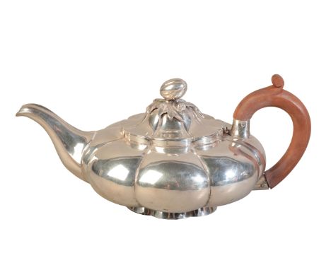 A GEORGE V SILVER TEAPOTby Henry Lambert, London 1914, of melon shape with conforming melon and leaf finial, the wooden handl