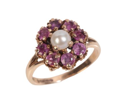 A PEARL AND RUBY CLUSTER RINGin 9ct gold, set with a mabé pearl of 4.6mm in a cluster of round cut rubies, totalling c.1.20 c