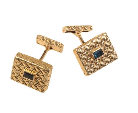 A PAIR OF VINTAGE SAPPHIRE CUFFLINKSin 18ct gold, each set with a step cut sapphire held in a rubover setting to a rectangula