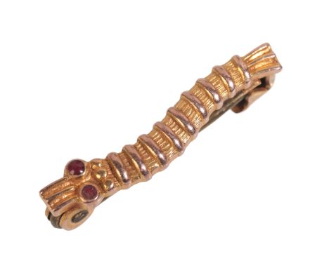 A WWII CATERPILLAR CLUB BROOCH in 9ct gold, ruby cabochon set eyes, engraved to the reverse 'W/O S.G.HOLROYD', secured with a