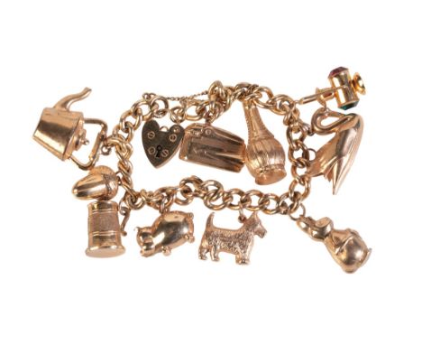 A VINTAGE CHARM BRACELET in 9ct gold, comprising a curb link chain bracelet, each link individually hallmarked, suspending te